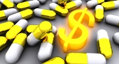 Molte pillole dorate con incandescente simbolo del dollaro d'oro