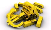 Sztabki złota i złoty symbol euro