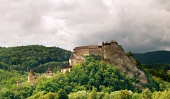 Majestic Orava Castle on green hill in cloudy summer day